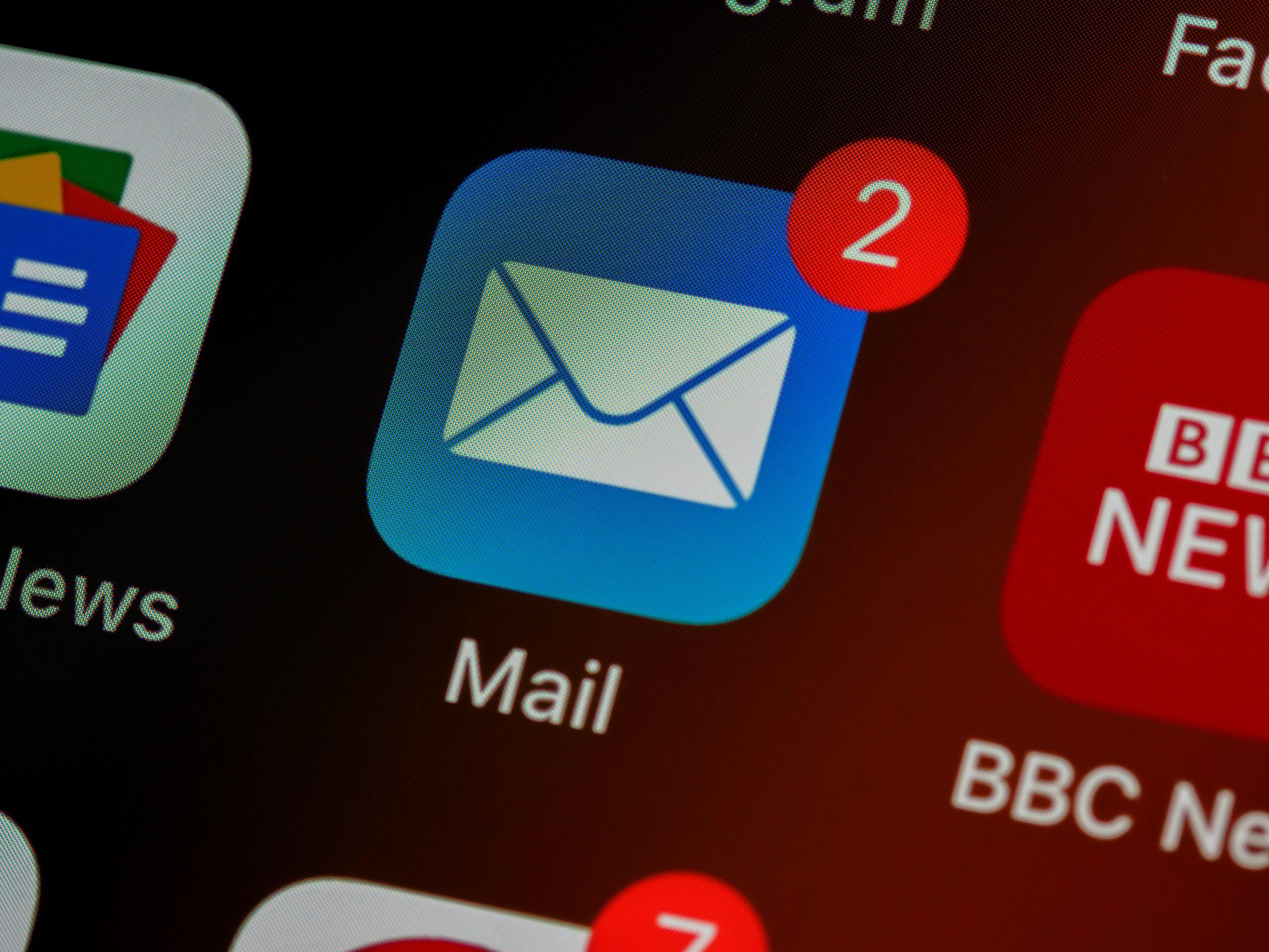 Mobile interface illustrating the concept of should I use email marketing for my small business, featuring a Mail app icon with a red notification badge showing '2' unread messages, alongside a BBC News app icon