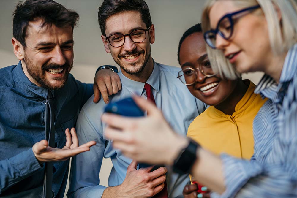 A group of coworkers at a small business enjoy one another’s company