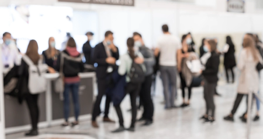 Unfocused image of a well-attended booth at a business expo