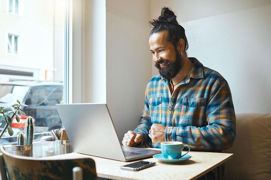 A small business owner smiles as he reviews his search metrics after implementing an SEO strategy