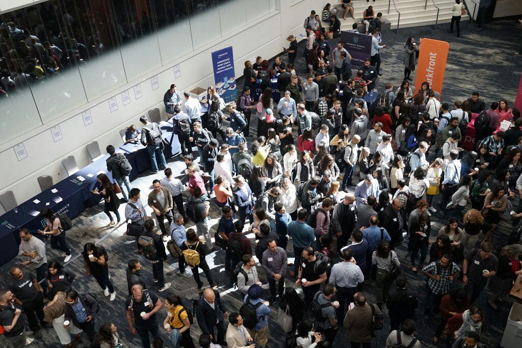 a group of people standing in a room similar to NYC Javits Center Events.