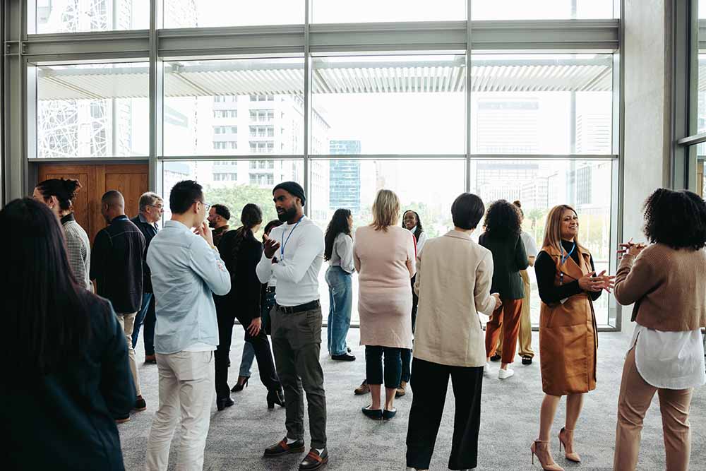 A corporate crowd mingles at a small business networking event